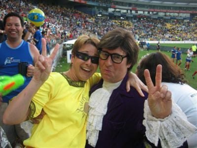 Austin Powers posing with fans at a stadium event