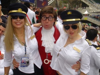 Austin Powers with two flight attendants at the Hong Kong Sevens