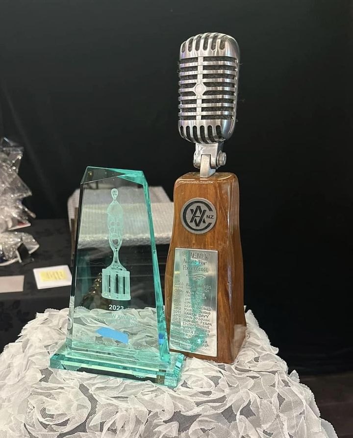 Glass entertainment award trophy with a vintage microphone