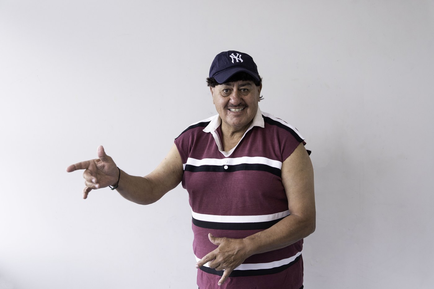 Gary Brown performing in a casual striped shirt and cap