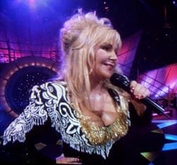 Dolly Parton tribute artist singing into a microphone
