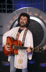 Elvis tribute artist with an acoustic guitar