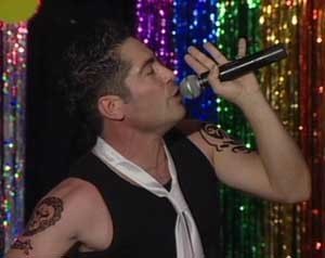 Male singer performing live with a handheld microphone