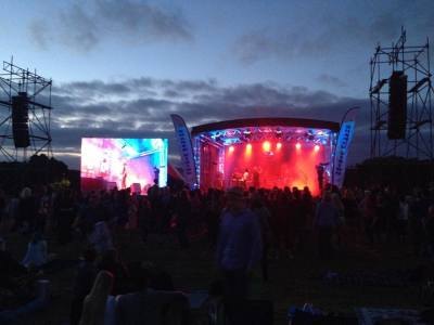 Large outdoor main stage lit up at dusk