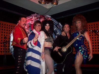 Tribute line-up on stage in costume including Austin Powers and Elvis